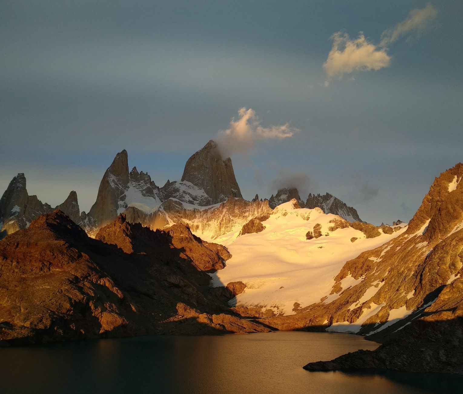 Sharp mountain peaks of Patagonia towering above wild grassland